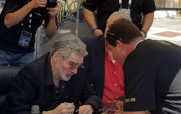 Actor Burt Reynolds signs autographs at the Barrett-Jackson auction