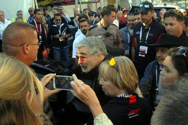 Burt Reynolds is escorted into an awaiting limo after selling 3 cars at Barrett-Jackson Collector Car Auction April 7, 2017